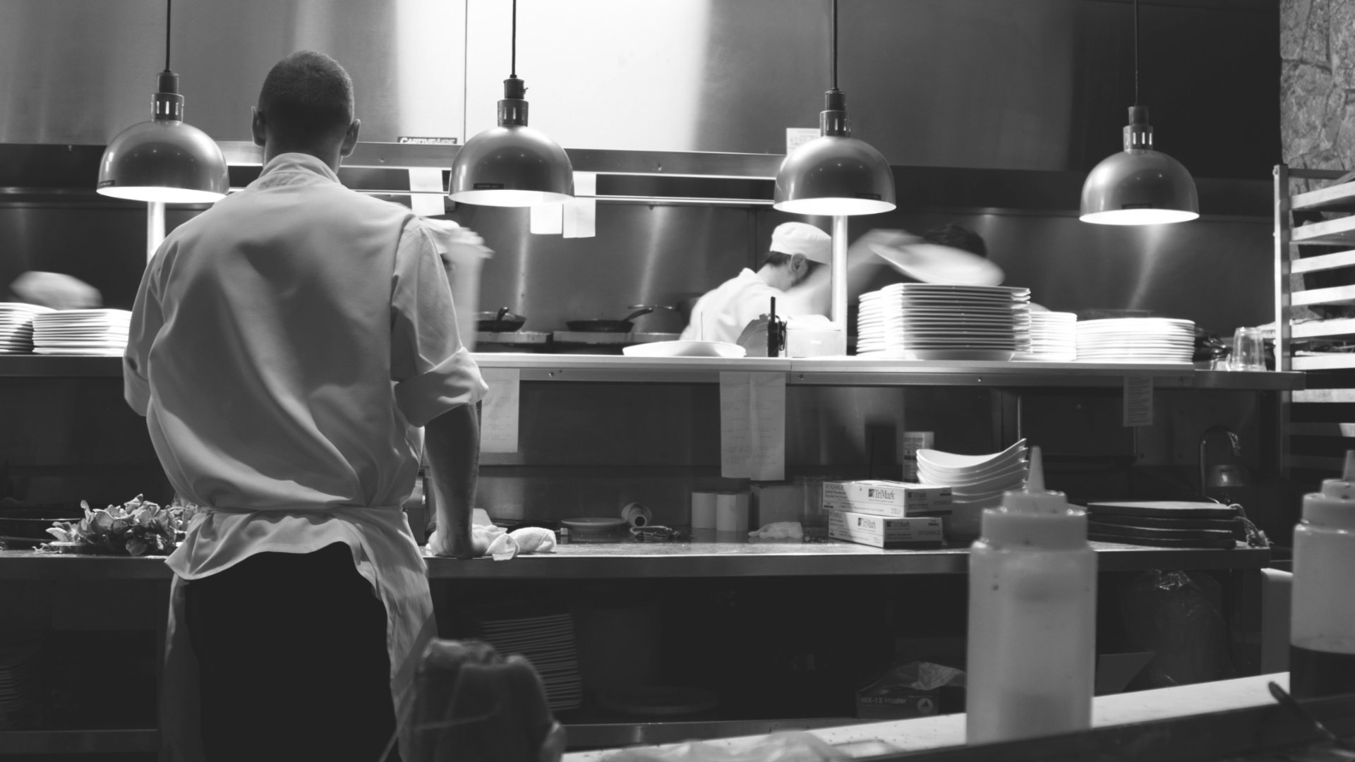 Picture of chef working in the back-house kitchen.